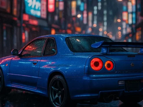 nissan-skyline-r34-gtr-azul-godzilla Nissan Skyline GT-R R34 azul, um ícone JDM e carro lendário, mostrando seu design agressivo e faróis traseiros circulares.