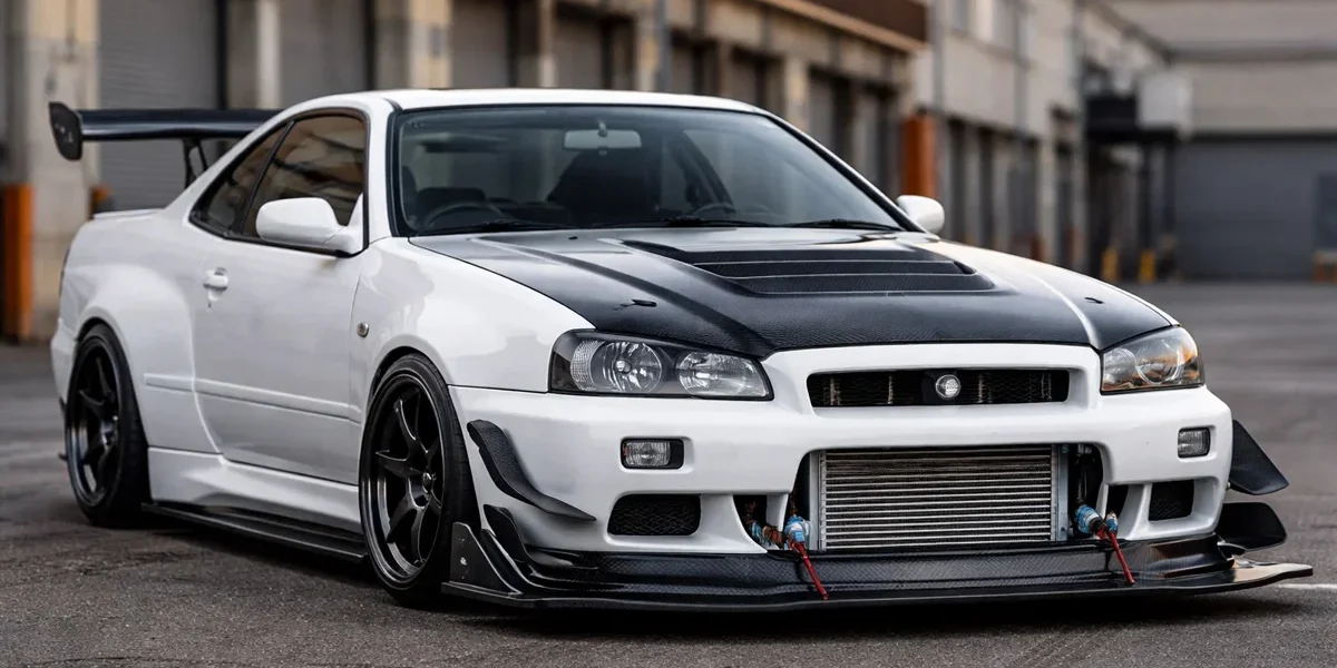 Nissan Skyline com modificações aerodinâmicas funcionais mostrando splitter de carbono e intercooler exposto.