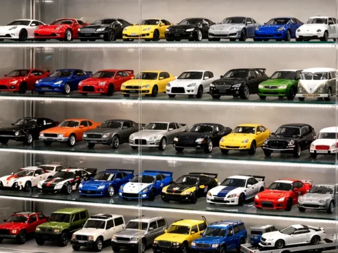 Vitrine de vidro iluminada com fitas de LED exibindo coleção de miniaturas automotivas livres de poeira e umidade.