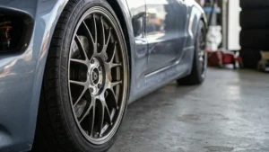 Roda esportiva montada rente ao para-lama de um carro, destacando o fitment agressivo proporcionado pelo uso de espaçadores.
